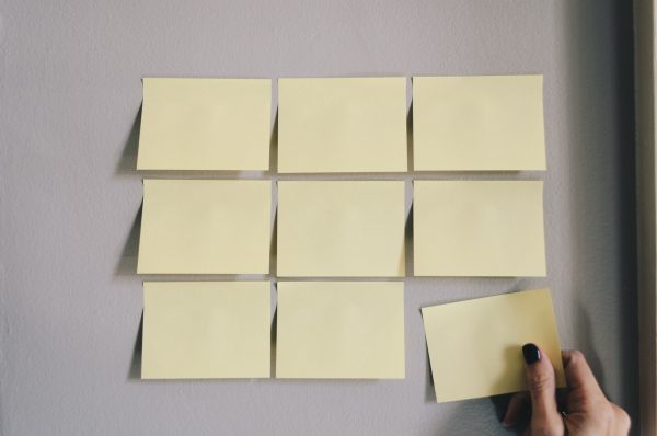 sticky notes plastered on a wall