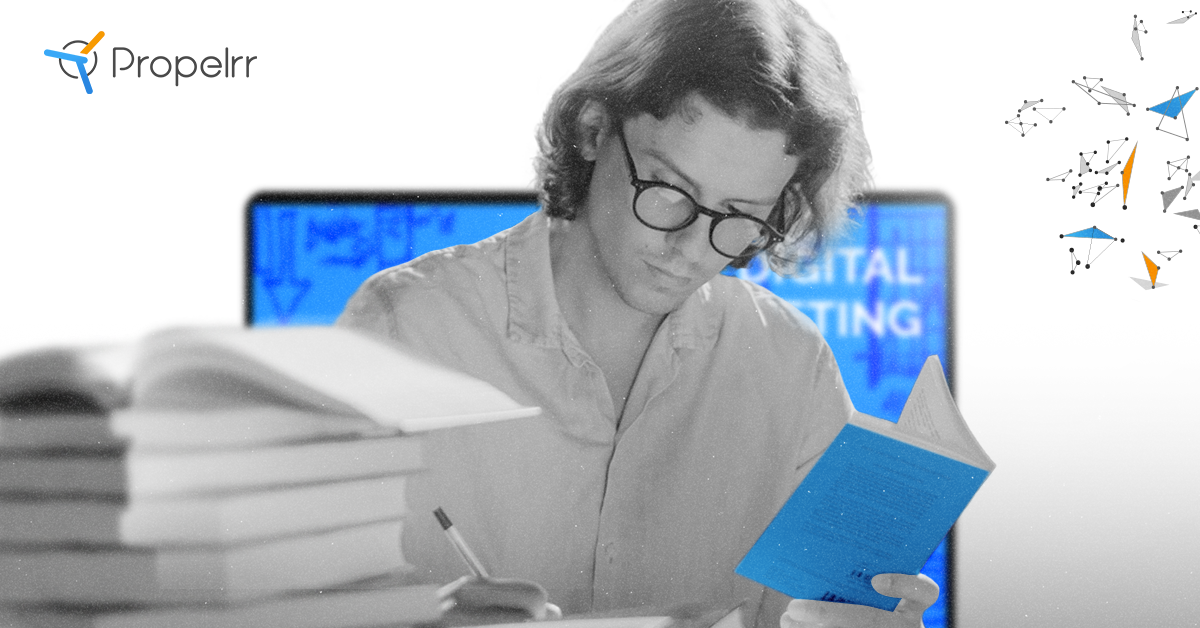 A man studying with a pile of books in the foreground